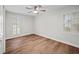 Bedroom with natural light, wood-look floors, a ceiling fan and two windows at 1043 Dominion Dr, Hanahan, SC 29410