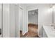Bright hallway with view of a bedroom featuring ceiling fan and closet at 1043 Dominion Dr, Hanahan, SC 29410