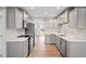 Modern kitchen featuring stainless steel appliances, custom cabinets, light countertops and beautiful wood flooring at 1043 Dominion Dr, Hanahan, SC 29410