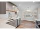 Bright kitchen showcases stainless steel appliances, light countertops and white cabinets, offering a clean and modern aesthetic at 1043 Dominion Dr, Hanahan, SC 29410