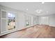 Inviting living space bathed in natural light, featuring hardwood floors and plantation shutters on the many windows at 1043 Dominion Dr, Hanahan, SC 29410