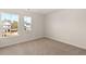 Bedroom with neutral carpet and view of the neighborhood through the windows at 105 Pen Shell St, Summerville, SC 29485