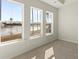 Well-lit bedroom featuring three large windows with scenic views of the community lake at 105 Pen Shell St, Summerville, SC 29485