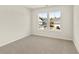 Bright bedroom featuring two windows with views of the front of the neighborhood and neutral decor at 105 Pen Shell St, Summerville, SC 29485
