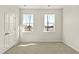 Bright bedroom featuring two windows offering scenic outdoor views and a neutral color scheme at 105 Pen Shell St, Summerville, SC 29485