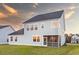 Rear exterior view showing light blue siding and a screened porch with a sunset backdrop at 105 Pen Shell St, Summerville, SC 29485