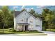 Charming two-story home with light blue siding, a covered porch, and an attached garage at 105 Pen Shell St, Summerville, SC 29485