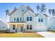 Beautiful two-story home with light blue siding, large windows, and a well-maintained lawn at 105 Pen Shell St, Summerville, SC 29485
