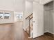 A hallway featuring wood floors, stairs, a coat closet, and a view into a bright living area at 105 Pen Shell St, Summerville, SC 29485