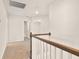 Bright hallway with neutral walls, carpet, and classic wood railing on the second floor at 105 Pen Shell St, Summerville, SC 29485
