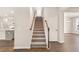 Inviting staircase with wood banister, carpeted steps, and views of the home's interior at 105 Pen Shell St, Summerville, SC 29485