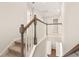 Upper staircase landing with wood banister, carpeted steps, and access to multiple rooms at 105 Pen Shell St, Summerville, SC 29485