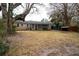 Large backyard with mature trees, leading to a screened porch on the back of the house at 1075 Quail Dr, Charleston, SC 29412