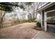 View of the expansive backyard with mature trees and brick accents near screen porch at 1075 Quail Dr, Charleston, SC 29412
