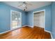 Relaxing blue bedroom features hardwood floors, ceiling fan, and closet at 1075 Quail Dr, Charleston, SC 29412