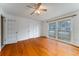 Bright bedroom with hardwood floors, ceiling fan, and a large window at 1075 Quail Dr, Charleston, SC 29412