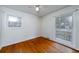 A bright bedroom with hardwood floors and natural light streaming through two large windows at 1075 Quail Dr, Charleston, SC 29412