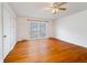 Spacious bedroom with hardwood flooring, a ceiling fan, and large windows at 1075 Quail Dr, Charleston, SC 29412