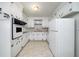 Functional kitchen with white cabinets and essential appliances, ready for updates at 1075 Quail Dr, Charleston, SC 29412