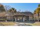 Community pool house featuring restrooms, palm trees, fencing and access gate at 109 Pavilion St, Summerville, SC 29483