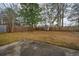 Expansive yard with a privacy fence, mature trees, and a small storage shed with a concrete patio at 111 Kennington Dr, Goose Creek, SC 29445