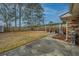 View of the backyard with a covered area, long driveway and partial view of brick on home exterior at 111 Kennington Dr, Goose Creek, SC 29445
