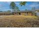 Expansive backyard featuring a brick home exterior, wooden privacy fence, and a covered parking area at 111 Kennington Dr, Goose Creek, SC 29445