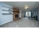 Carpeted basement featuring a brick fireplace, built-in shelves, a ceiling fan, and space for exercise equipment at 111 Kennington Dr, Goose Creek, SC 29445