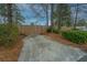 Long driveway leading to a fenced backyard surrounded by large trees and established shrubbery at 111 Kennington Dr, Goose Creek, SC 29445