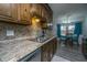 Well-appointed kitchen with wooden cabinets, granite countertops and a stainless steel sink at 111 Kennington Dr, Goose Creek, SC 29445