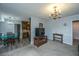Living room with wood floors, television, adjacent kitchen and chandelier at 111 Kennington Dr, Goose Creek, SC 29445