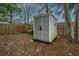 Resin storage shed nestled in a private, fenced backyard with mature trees and landscaping at 111 Kennington Dr, Goose Creek, SC 29445