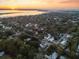 Panoramic aerial view of a coastal neighborhood at sunset, showcasing the serene waterfront and surrounding residential area at 1119 Simmons St, Mount Pleasant, SC 29464