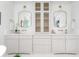 Elegant bathroom featuring double sinks, decorative mirrors, and ample cabinet space at 1119 Simmons St, Mount Pleasant, SC 29464
