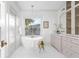 Bright bathroom with a freestanding tub, picture window, and elegant fixtures at 1119 Simmons St, Mount Pleasant, SC 29464