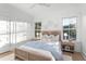 Bright bedroom with a comfortable bed, natural wood nightstands, and a large window at 1119 Simmons St, Mount Pleasant, SC 29464
