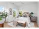 Bright bedroom showcasing a comfortable bed, neutral decor, and natural light from windows at 1119 Simmons St, Mount Pleasant, SC 29464