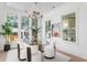 Bright dining room with a modern chandelier, glass-top table, and oversized windows at 1119 Simmons St, Mount Pleasant, SC 29464