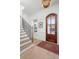 Bright foyer with hardwood floors, an elegant staircase, and a stylish front door at 1119 Simmons St, Mount Pleasant, SC 29464