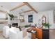 Bright living room with white sofas, fireplace, wood beams, and stylish decor creating a cozy atmosphere at 1119 Simmons St, Mount Pleasant, SC 29464