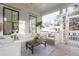 Inviting outdoor porch features stylish seating, a coffee table, and white shiplap walls at 1119 Simmons St, Mount Pleasant, SC 29464