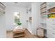 Spacious walk-in closet with custom shelving, a window, and a seating area at 1119 Simmons St, Mount Pleasant, SC 29464