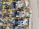 Aerial view of multiple luxury beachfront homes featuring pools and private beach access at 112 Ocean Blvd, Isle of Palms, SC 29451