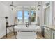 Coastal bathroom with a freestanding tub and an ocean view at 112 Ocean Blvd, Isle of Palms, SC 29451