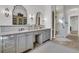 Bright bathroom featuring dual vanities with ornate mirrors and sconces, plus glass shower at 112 Ocean Blvd, Isle of Palms, SC 29451
