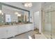 This immaculate bathroom features a beautiful glass door shower and double sinks at 112 Ocean Blvd, Isle of Palms, SC 29451