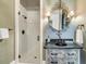 Elegant bathroom featuring a walk-in shower and designer vanity with decorative mirror and sconces at 112 Ocean Blvd, Isle of Palms, SC 29451