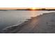 Serene beach scene at sunset, showcasing the natural beauty and tranquility of the coastal environment at 112 Ocean Blvd, Isle of Palms, SC 29451