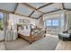 Bright bedroom featuring vaulted ceilings, exposed beams, and private balcony access with great views at 112 Ocean Blvd, Isle of Palms, SC 29451