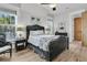Bright bedroom showcasing a decorative bed frame, wood floors, and natural light through large windows at 112 Ocean Blvd, Isle of Palms, SC 29451